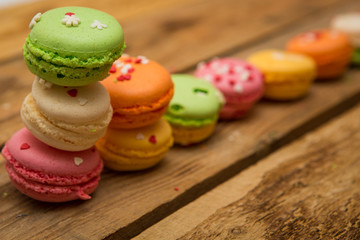 colored French macaroons on a wooden table