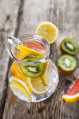 Refreshing ice cold water with lemon, kiwi and grapefruit