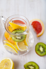 Refreshing ice cold water with lemon, kiwi and grapefruit