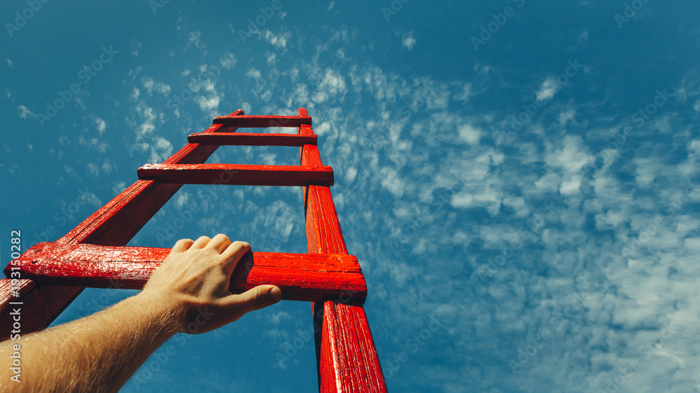 Wall mural development attainment motivation career growth concept. mans hand reaching for red ladder leading t