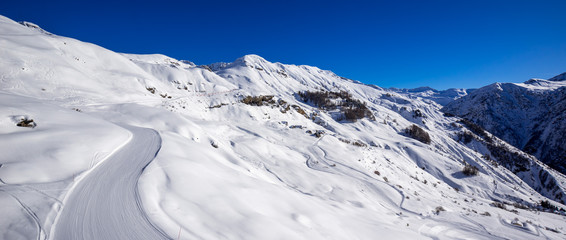 Obraz premium Panoramic view of the slopes of Orcieres-Merlette ski resort in Winter. Hautes-Alpes, Ecrins National Park, Champsaur, Alps, France