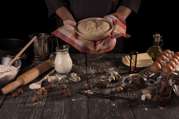 Ingredients for baking and ready-made dough in bowl