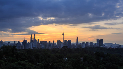 Fototapeta na wymiar Beautiful aerial view of Kuala Lumpur city skyline, skyscraper during sunrise with dramatic sky, clouds and sun rays.