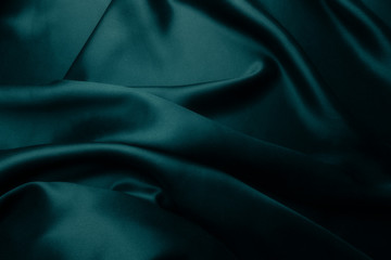 Fototapeta premium Elegancki niebieski satynowy jedwab z falami, abstrakcyjne tło