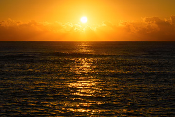 Golden beach sunrise or sunset over the sea
