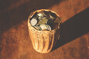 russian coins in wicker vase on wooden surface