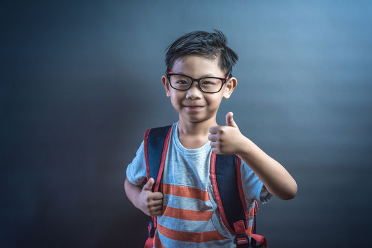 asian kid with thumbs up agreeing and giving his approval.portrait of happy boy