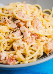 Tasty pasta with bacon and cheese. Selecitve focus.