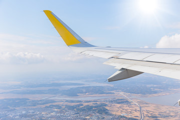 Fototapeta premium plane wing flying over earth landscape view background