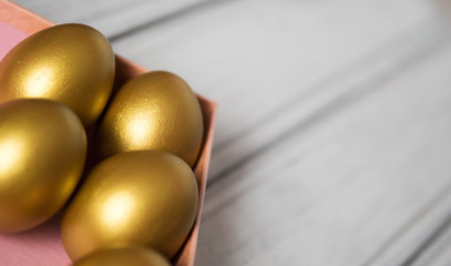Golden Easter eggs in gift box copy space
