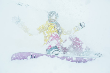 Snowy photo of woman with snowboard on winter mountain slope