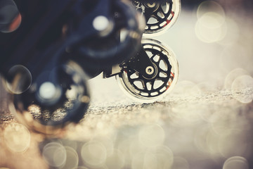 Road and wheels of roller skates closeup