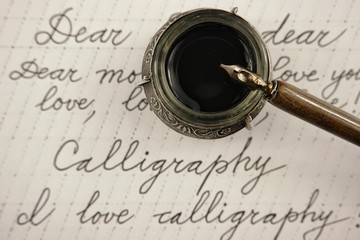 Handle and inkwell with black ink on calligraphy background