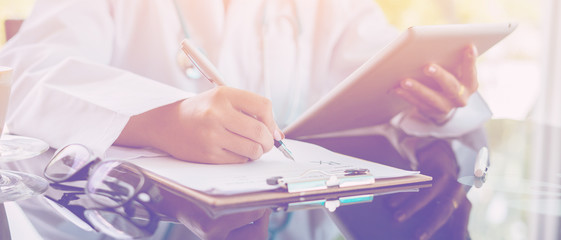 Female doctor prescribes medication. prescription pills are prescribed by doctors,Medical Exam,Healthcare and medically concept,test results with digital tablets ,vintage color,selective focus