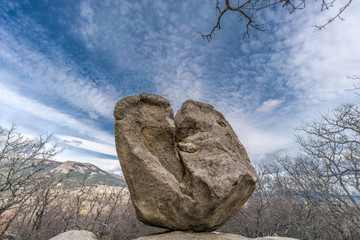 Celtic Vetton sacred place (Nemeton), Large boulder of granite rock surounded by trees at Silla de...