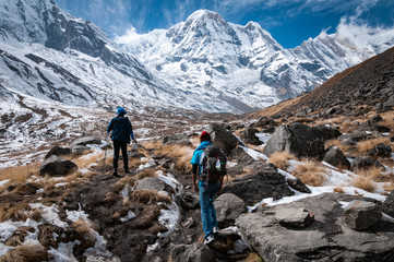 people trekking in the himalayan mountains