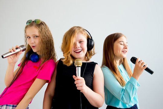 Girls singing in headphones