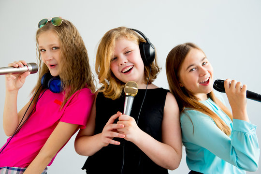 Girls singing in headphones