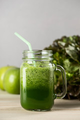 Green detox juice jar with green vegetables.