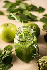 Green detox juice jar with green vegetables