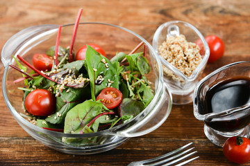 a salad of fresh greens and sesame seeds with soy sauce, Asian national cuisine