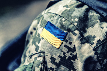 military badge of ukrainian army with trident and yellow-blue flag