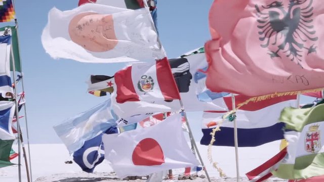 Detail flags of all over the world waving with the wind in the most touristic place, Salt flats of Uyuni, Bolivia