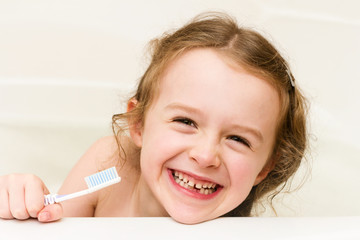 Funny little school girl lost her milk tooth