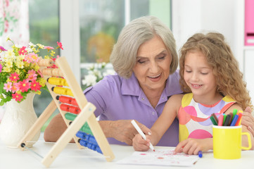grandmother and granddaughter doing homework