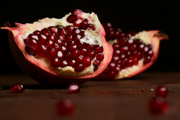 Pomegranate pieces on the table, pomegranate still life