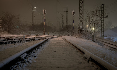 Snowy railway at night