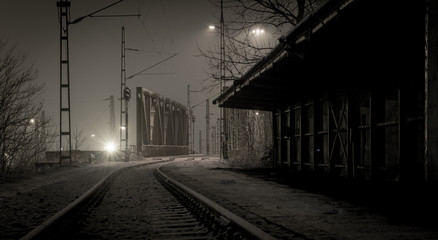 Empty, snowy railway station at night