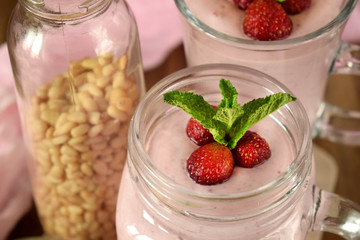 Protein cocktail with strawberries and mint in a glass jar