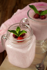 Protein cocktail with strawberries and mint in a glass jar