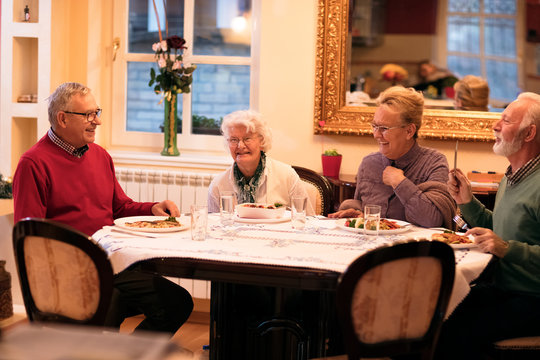 Senior People Enjoy And Smiling While Eating Dinner