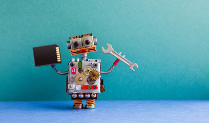Robot handyman memory flash card hand wrench. Fixing maintenance concept. Creative design toy, cogs...