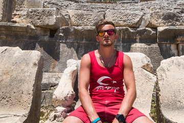 Young man at theatre in Myra ancient city of Antalya in Turkey.