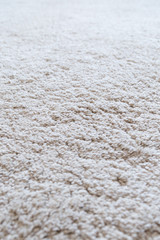 Close-up of a white shaggy carpet, shallow depth of field.