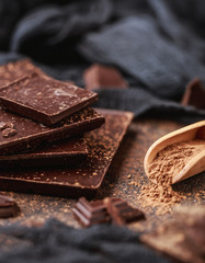 Chocolate bar pieces. Background with chocolate. Sweet food photo concept. The chunks of broken...