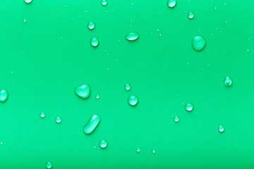 Drops of water on a color background. Green. Toned