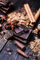 Chocolate bar pieces. Background with chocolate. Sweet food photo concept. The chunks of broken chocolate