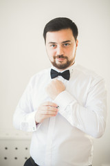 Beautiful man, groom posing and preparing for wedding