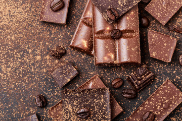 Chocolate bar pieces. Background with chocolate. Sweet food photo concept. The chunks of broken chocolate