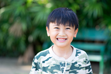 Portrait of Asia kid boy smiling with teeth and gums.