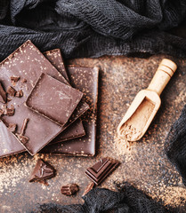 Chocolate bar pieces. Background with chocolate. Sweet food photo concept. The chunks of broken...