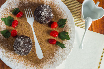 chocolate cake with kumquat on a white plate