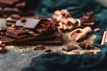 Chocolate bar pieces. Background with chocolate. Sweet food photo concept. The chunks of broken...