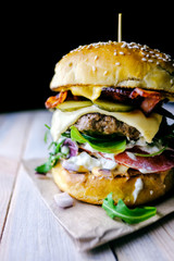 Appetizing cheeseburger on wooden table. Flat lay. Food photography