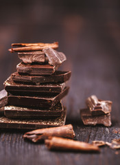 Chocolate bar pieces. Background with chocolate. Sweet food photo concept. The chunks of broken...
