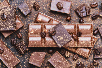 Chocolate bar pieces. Background with chocolate. Sweet food photo concept. The chunks of broken chocolate